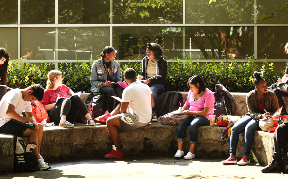 Students sit around Magnolia Avenue Campus courtyard
