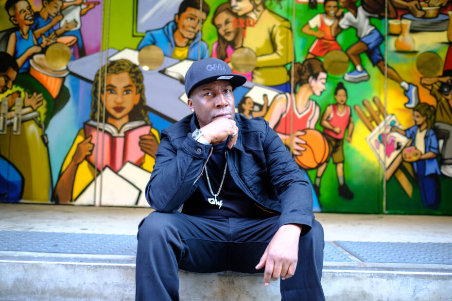 Hip-hop pioneer Grandmaster Flash in front of a colorful mural