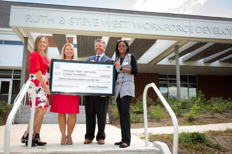 Christy Newman of Arconic presents $80,000 grant to Pellissippi State in front of Ruth and Steve West Workforce Development Center