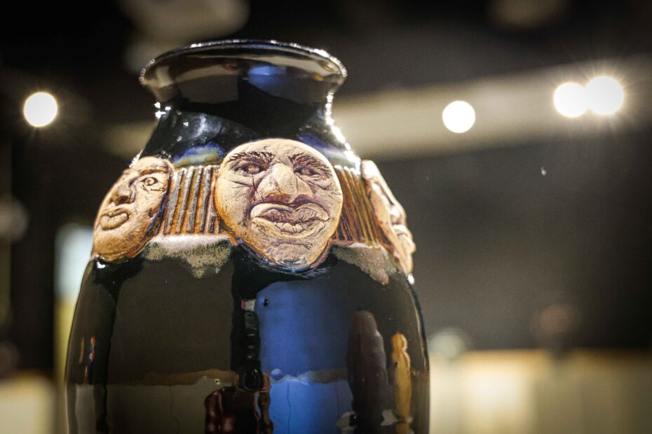 Ceramic vase with faces on it by Bill Capshaw