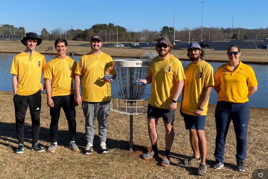 Pellissippi State Disc Golf players Grady Williams, Ian Smith, Chris Berney, Jacob Teffeteller and Derek Rucker, from left, join Coach Leslie Adamczyk, far right, in celebrating their team and individuals wins at The Smokie Showdown on the Hardin Valley Campus Feb. 3.